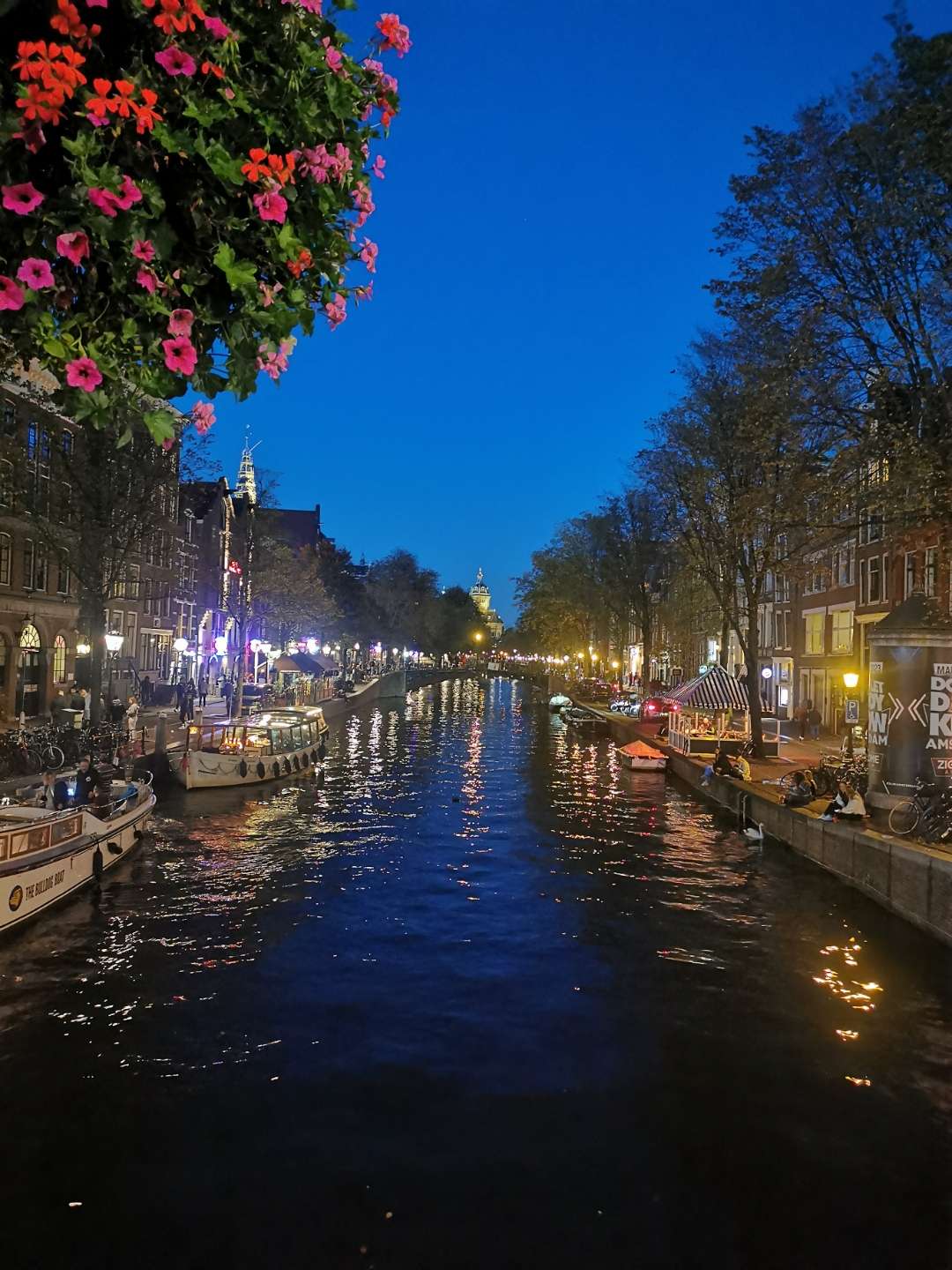 Amsterdam canal at blue hour with reflections and bridge