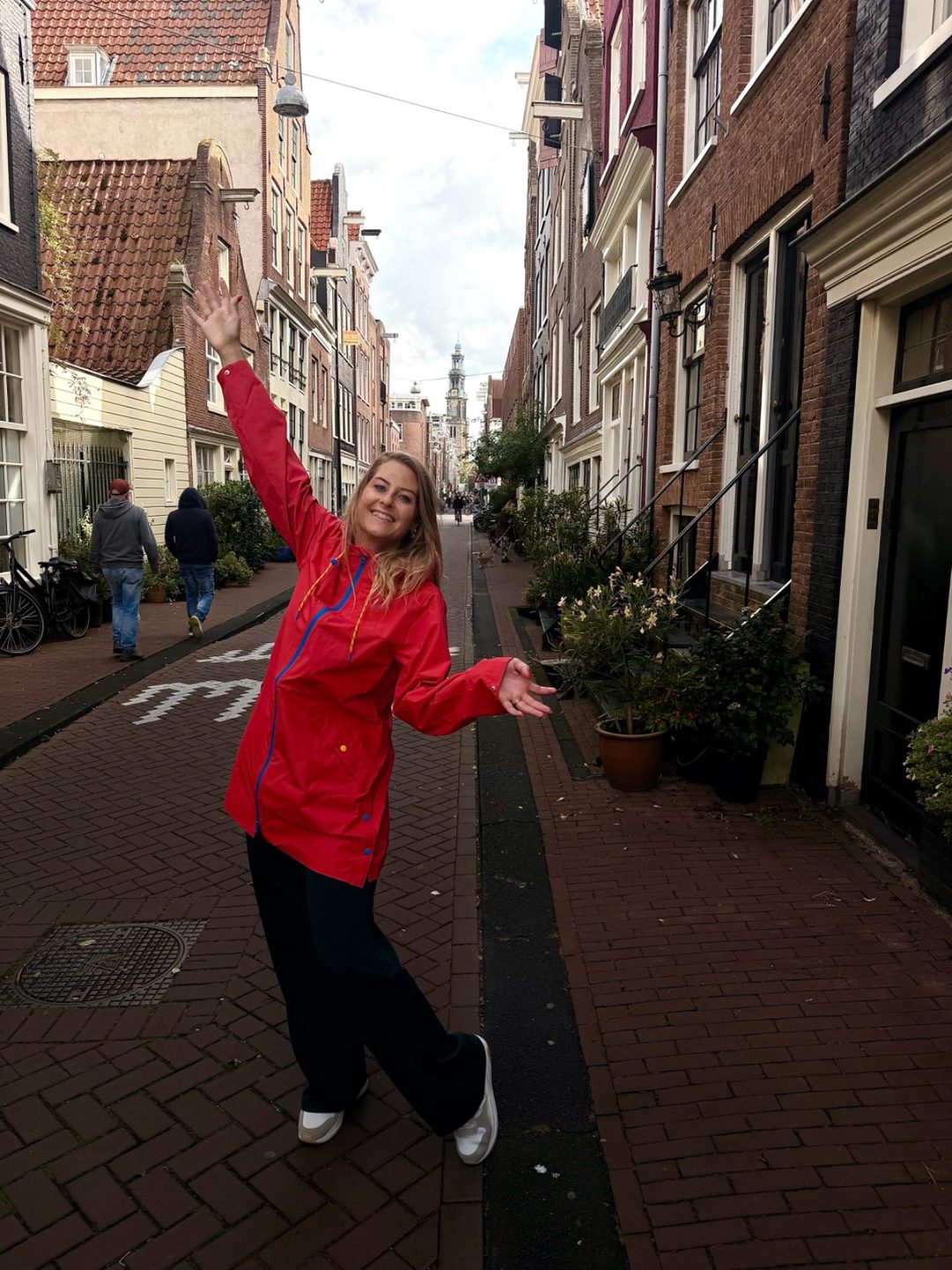 Timm in a narrow Amsterdam street with the Westerkerk tower in the distance